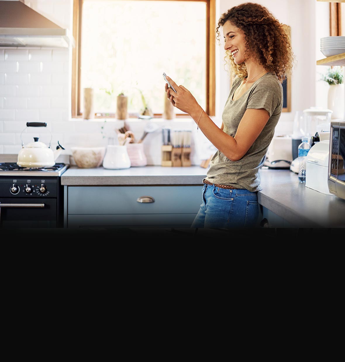 woman on mobile phone in kitchen