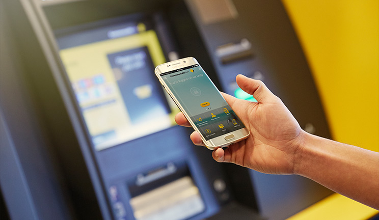 Mobile phone with CommBank app, near an ATM